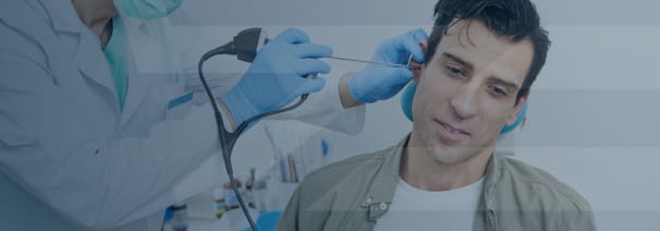 patient being treated with a scope in his ear