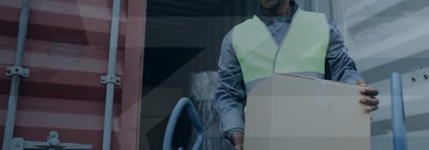 worker carrying a box to be put on a delivery truck